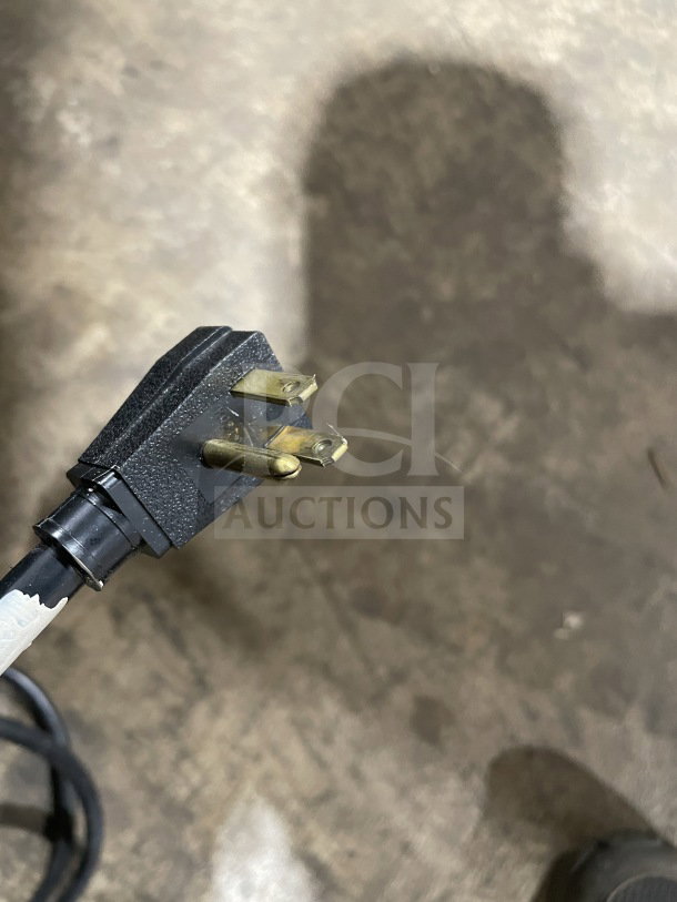 Close-up of plug for True GDM-49 commercial refrigerator. Features include 115V power, 1 phase.