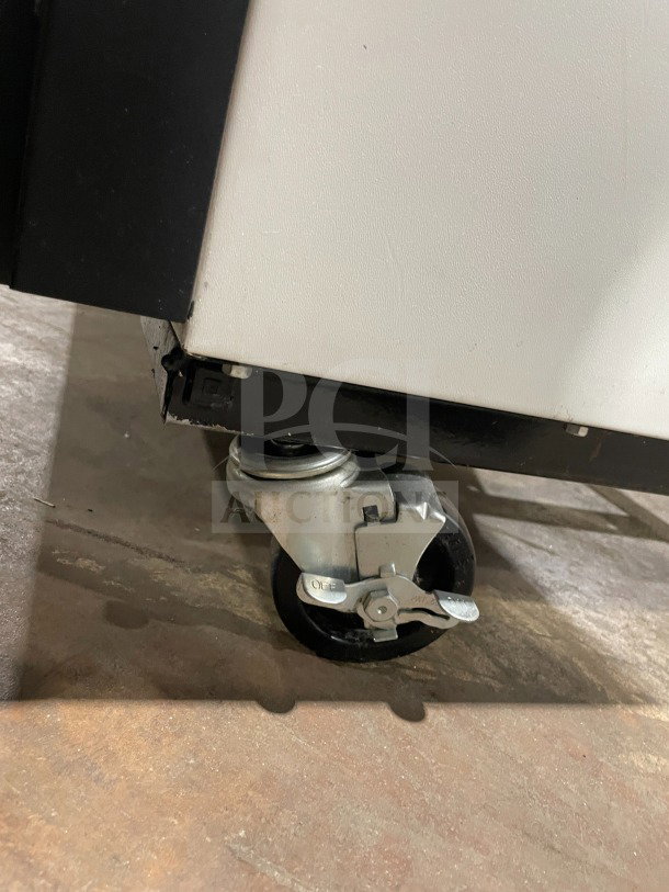 True GDM-49 commercial refrigerator caster wheel, showing locking mechanism. Model GDM-49, SN 1-3691030.