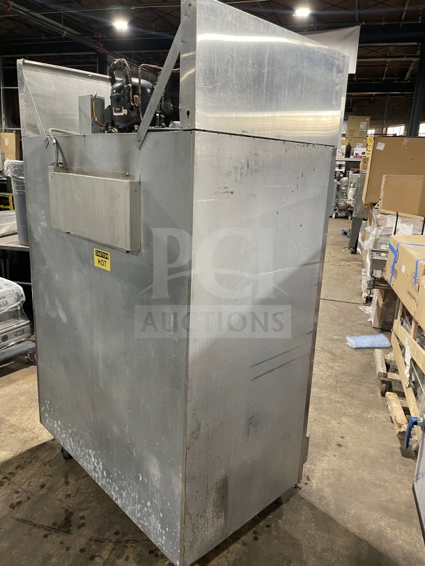Victory FAA2057 commercial 2-door freezer on casters; visible surface wear; caution label indicates "CAUTION HOT."
