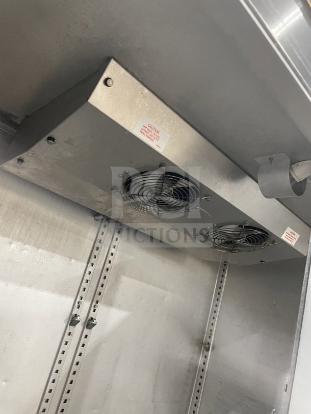 Victory FAA2057 2-door freezer interior, showing fans and metal shelving rack, in used condition. On casters, 115V.