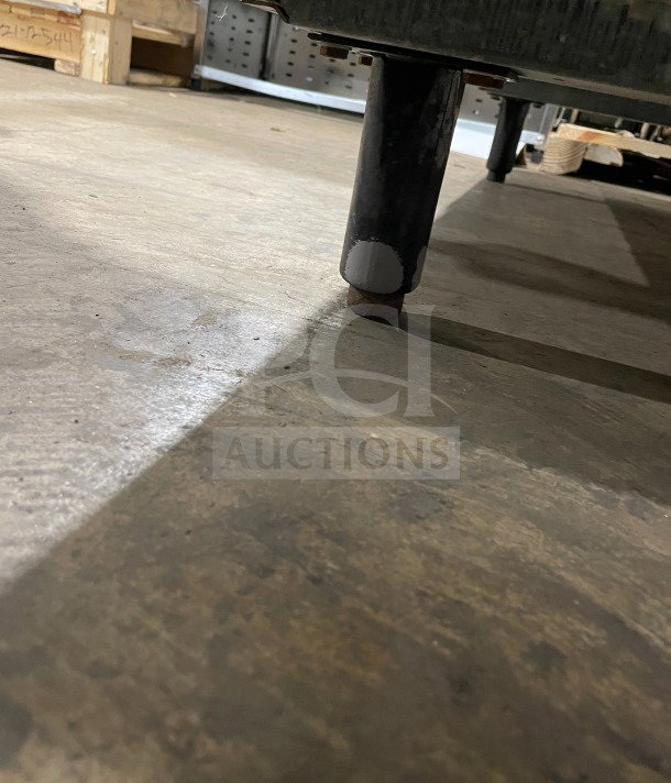Victory stainless steel refrigerator leg, sturdy condition, on concrete floor.