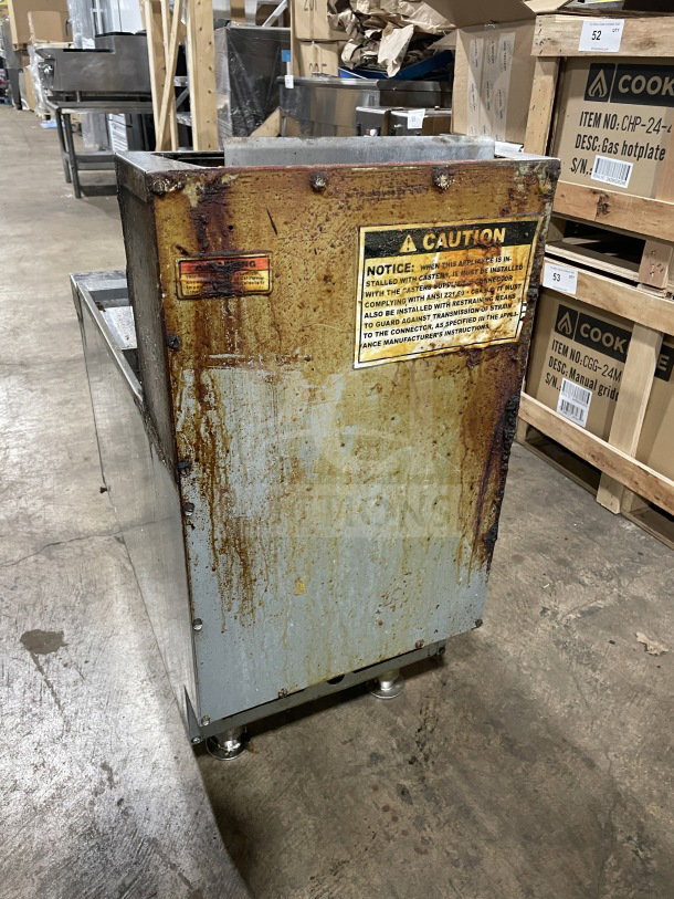Cooler Depot commercial stainless steel gas fryer, Model CTF3. Features backsplash, basket hanger, and legs. Visible wear and caution labels.