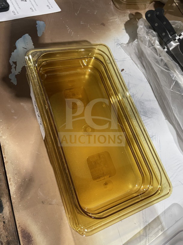 Brand new rectangular amber food storage container, clear and stackable design, suitable for kitchen use.