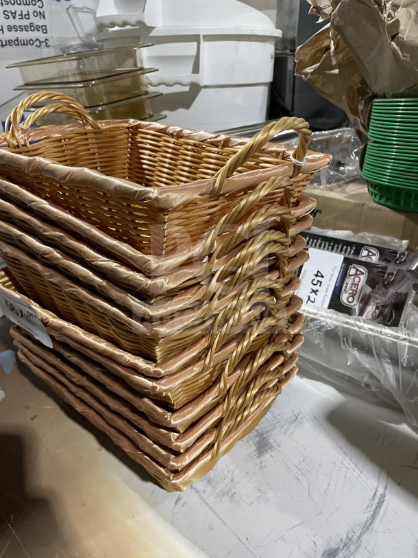 Stack of commercial polypropylene synthetic wicker display baskets with handles, in excellent condition.