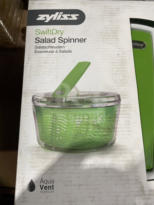 Brand new Zyliss SwiftDry Salad Spinner in box, green design, featuring single-handed operation and Aqua Vent technology.