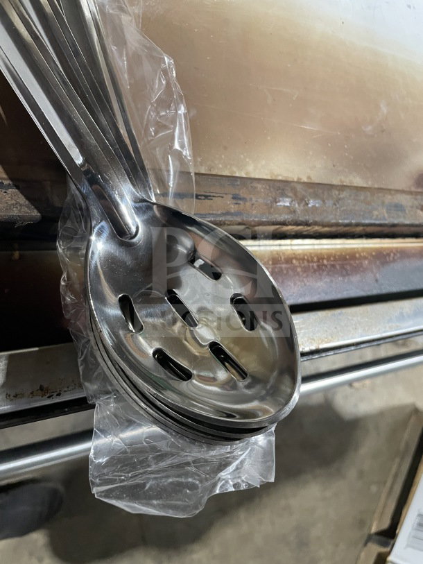 Winco BSSN perforated stainless steel buffet spoon in new condition, wrapped in plastic. Ideal for commercial serving.