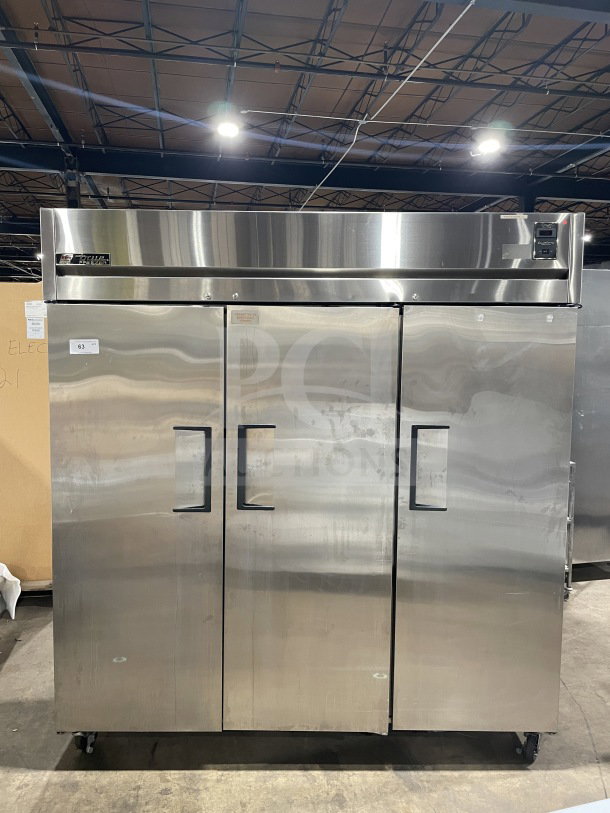 True 78" Commercial 3-Door Freezer, Model TR3F3S, stainless steel, on casters, with chrome-plated wire rack.
