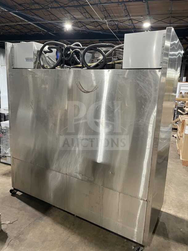 True 78" stainless steel 3-door commercial freezer, Model TR3F3S, with chrome rack, on casters, 1 phase, visible wear.