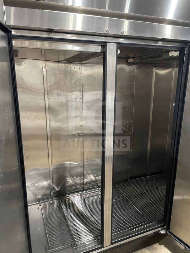 True 78" stainless steel 3-door commercial freezer, model TR3F-3S, with chrome plated wire racks and casters.