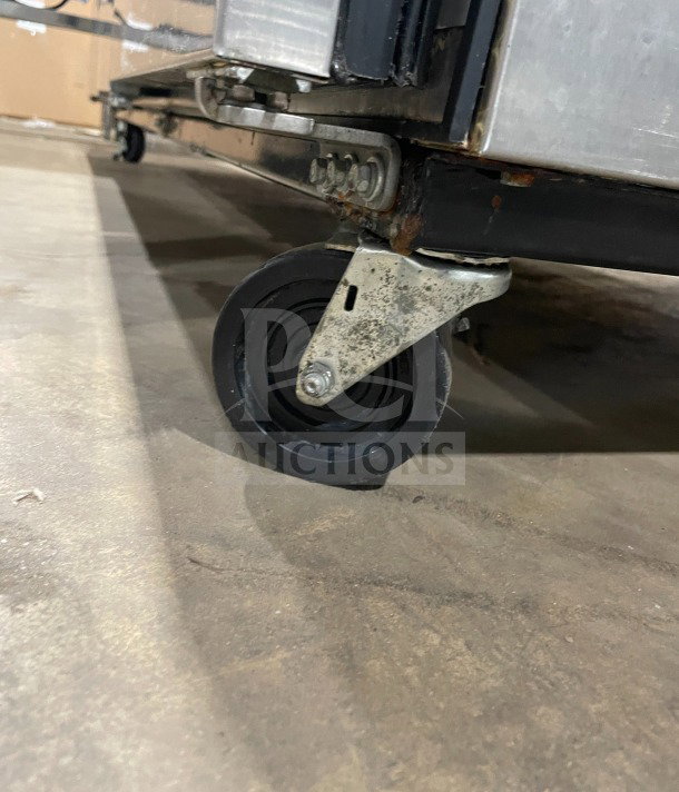 Lower part of True 78" commercial freezer model TR3F-3S on casters, highlighting caster wheel and base structure.