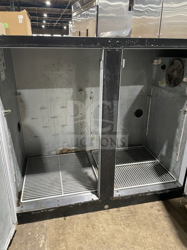 Beverage Air BB48Y1B black 2-door bar back cooler with poly-coated racks, model SN: 9903231, showing interior storage.
