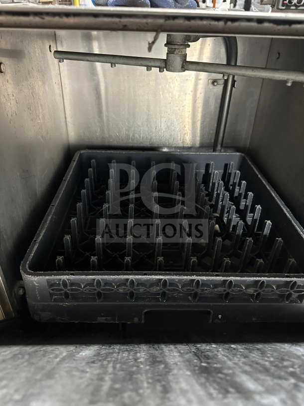 Noble WAREFORCEUL30 undercounter dishwasher showing interior, stainless steel design, with rack and spray arm.
