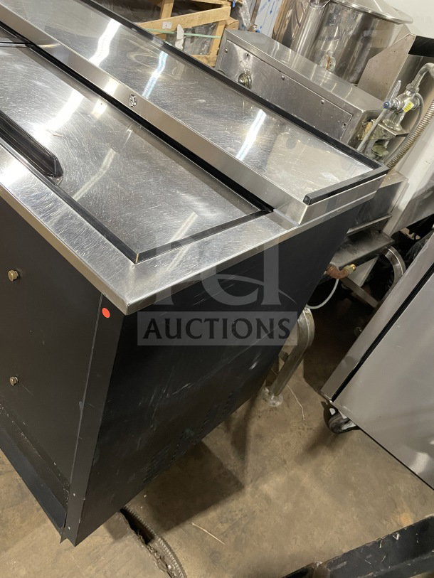 Avantco 95" black commercial beer bottle cooler, model 178JBC95B, with three sliding doors, heavy-duty, on casters.