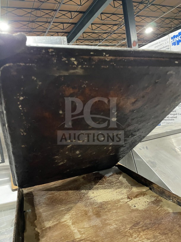 Commercial aluminum full-size baking sheet pan, showing signs of heavy use with discoloration and wear. Auction item.