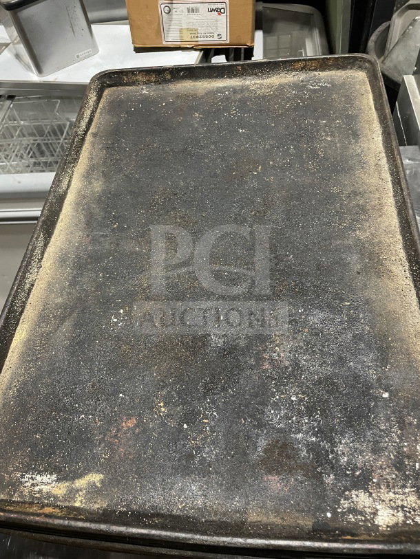 Commercial aluminum full-size baking sheet pan, used condition, visible wear from baking, suitable for high-volume use.