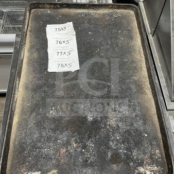 Commercial full-size aluminum baking sheet pan, used condition, visible wear. Tags show auction details and quantities.