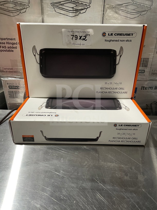 Alt text: Le Creuset Toughened Nonstick 10"x14" Rectangular Griddle in box, brand new condition, auction label visible.
