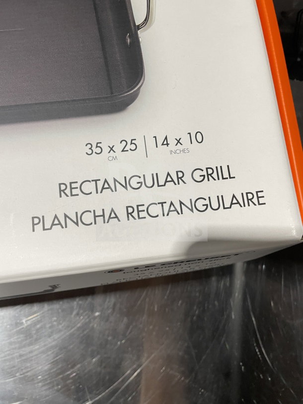 BRAND NEW Le Creuset 10"x14" rectangular nonstick griddle in box. Visible label: "Rectangular Grill, 35x25 cm."