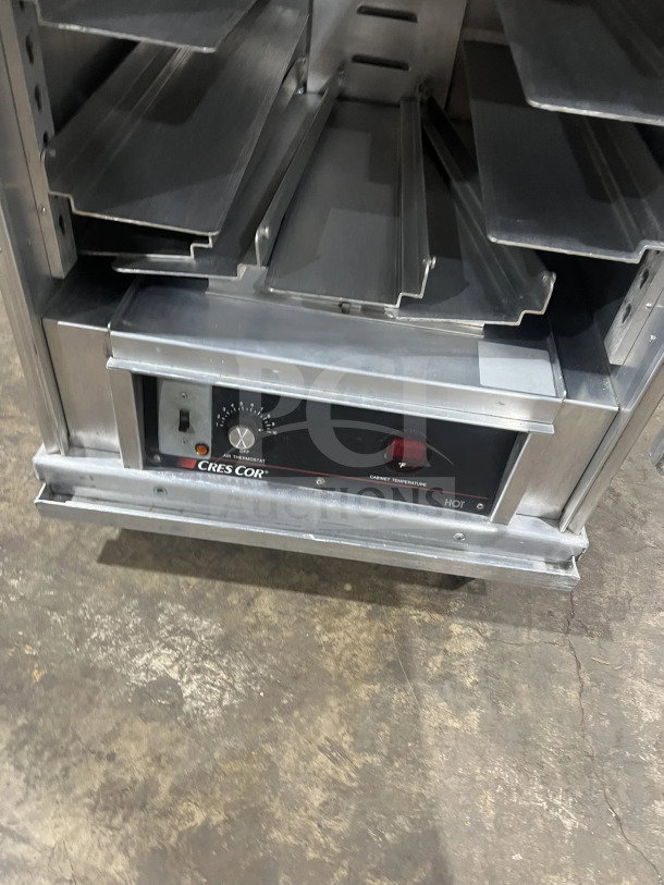 Cres Cor stainless steel heated holding cabinet, model 1290006, with built-in pan slides, 120V, on casters, in good condition.
