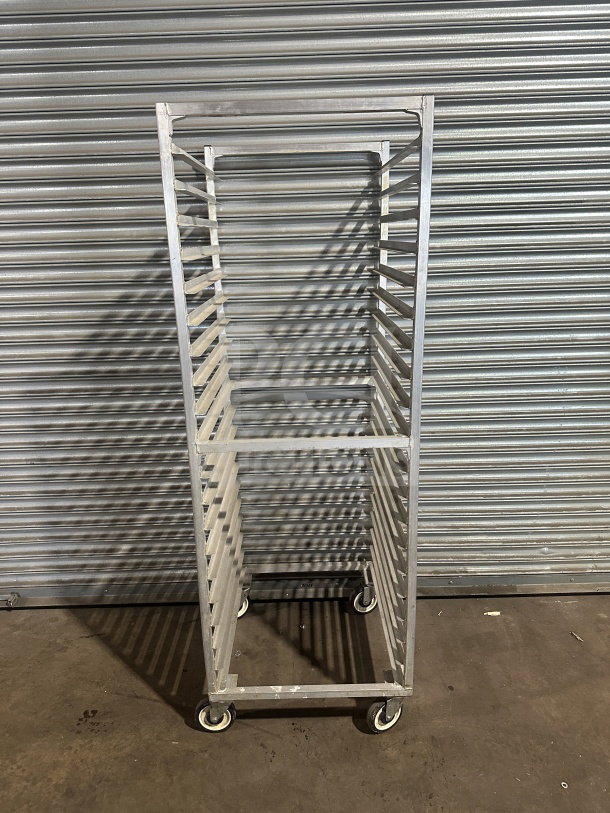 Commercial stainless steel heavy-duty sheet pan rack on casters, excellent condition, multiple shelves, durable design.