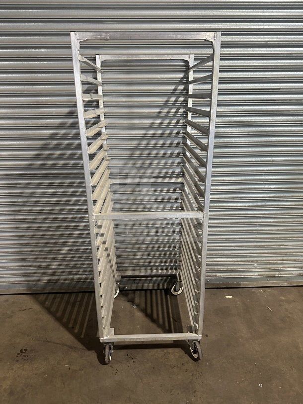 Commercial stainless steel heavy-duty sheet pan rack on casters, multiple tray slots, excellent condition.