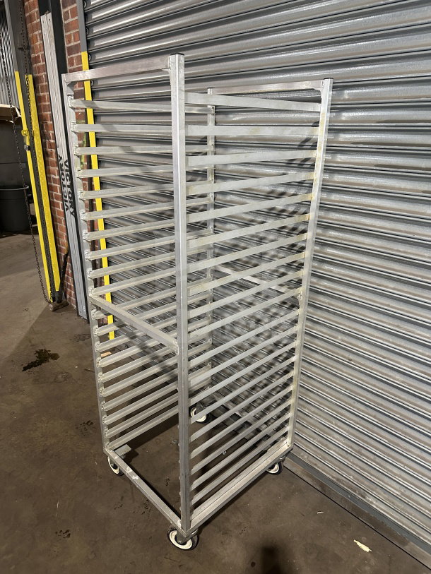 Commercial stainless steel heavy-duty sheet pan rack with casters, 18 slots, in good condition, ideal for kitchen use.