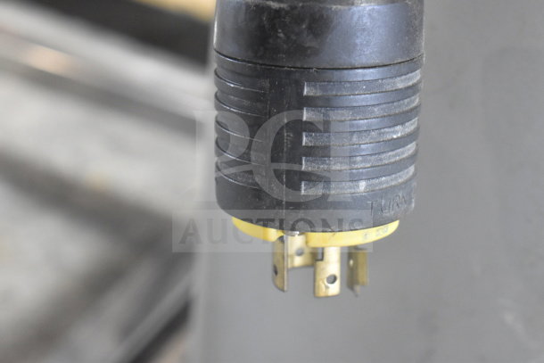 Close-up of the power plug for a Hobart M-802 commercial dough mixer, showing the prongs and part of the cable.