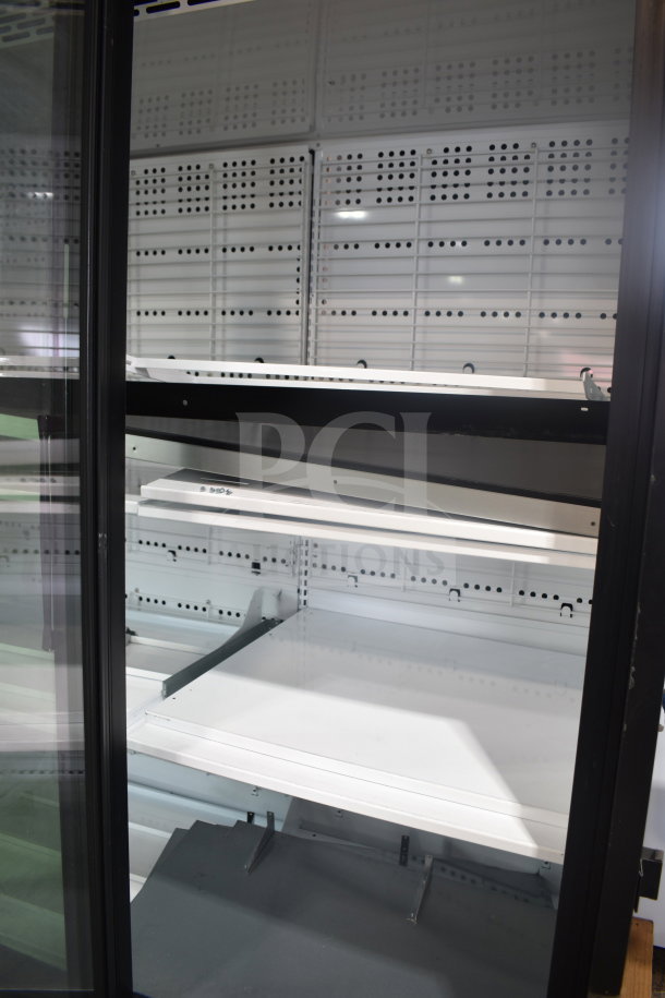 True TRM3M-YY-BLK-WHT-1BLKLLL-4 commercial black refrigerated merchandiser with 3 glass doors and LED lighting.