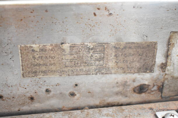 Baxter OV310G commercial rack oven label showing model and serial number, moderate wear.
