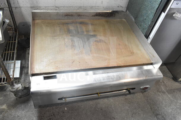 Wells Commercial Gas Flat Top Griddle, countertop model, well-used condition, stainless steel body, visible grime on cooking surface.