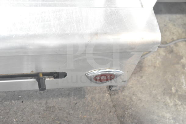 Wells Commercial Gas Flat Top Griddle. Stainless steel, countertop model, visible Wells logo, slightly worn condition.