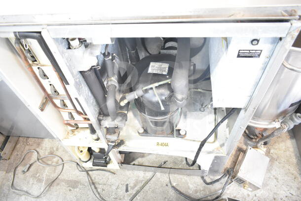 Hoshizaki KM-900MAH commercial ice machine head. Interior components visible. Model details on label. 208-230 Volts, 1 Phase.