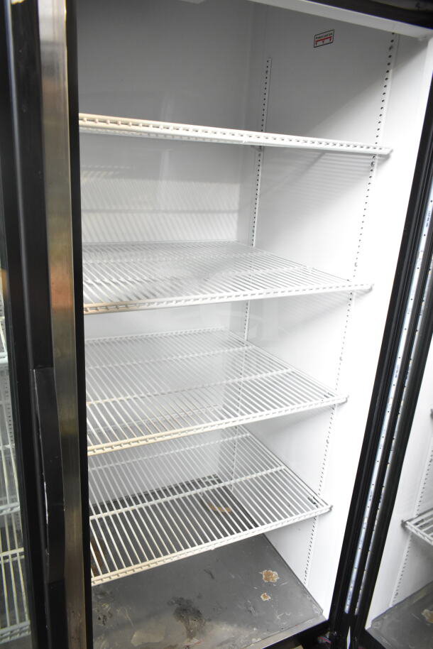 2019 True GDM-49-HC commercial cooler with two glass doors and white wire shelves, 115V, working condition.