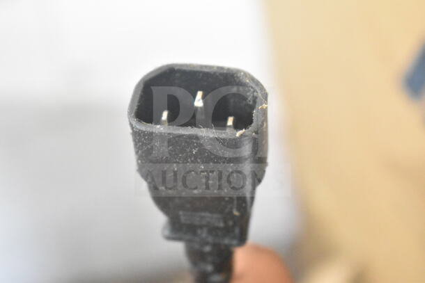 Close-up of a power plug for the 2024 Frontline 10SS-NA-WM Fryer Oil Transport Caddy, showcasing prongs and casing condition.