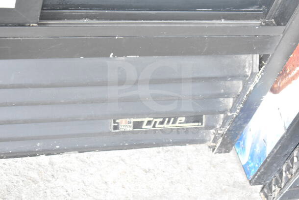 True GDM-33 commercial 2-door cooler, black exterior with manufacturer label visible. 115 volts, 1 phase.