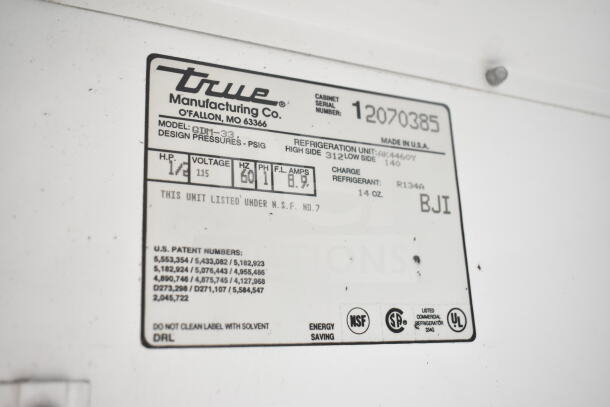 True GDM-33 Commercial 2 Door Reach In Cooler, 115V, 1 Phase, label shows model and specs, NSF approved.