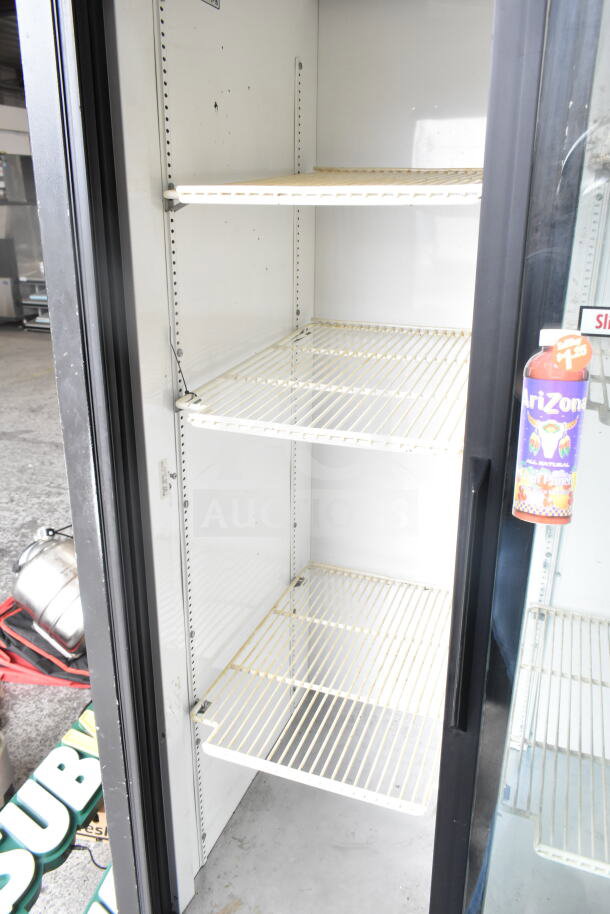 True GDM-33 commercial 2-door reach-in cooler merchandiser, 115 volts, three adjustable shelves, clean interior.