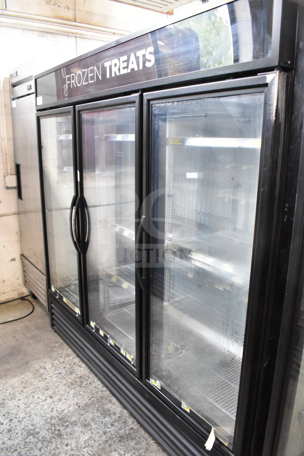 2018 True GDM-72F-HC 3-door reach-in freezer merchandiser, black frame, "Frozen Treats" label, tested working condition.