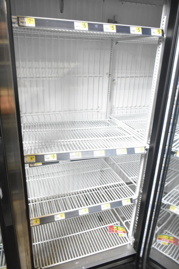 2018 True GDM-72F-HC commercial 3-door freezer, tested and working, 115/208-230V, 1 phase, with shelving and sale tags.
