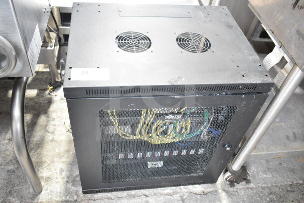 Tripp Lite AV cabinet with contents, featuring mesh front, visible wiring, ventilation fans, and branded logo.