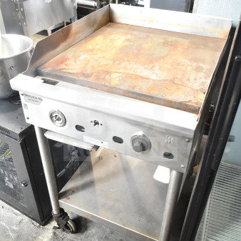 Jade Range countertop gas griddle with under shelf, used, visible rust on cooking surface, mounted on wheeled legs.