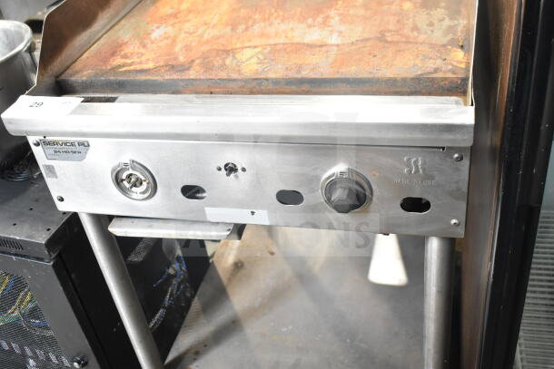 Jade Range commercial gas griddle with rusted flat top and under shelf, control knobs, and Service PL label visible.