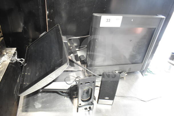 POS system with 2 monitors and 2 speakers, model PAR. Monitors appear in good condition with visible cables.