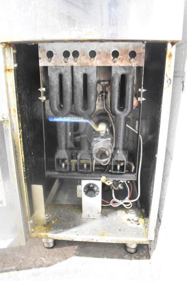 Cook Rite ATFS-40 gas fryer internal view, showing burner components; used condition with visible wear and residue.