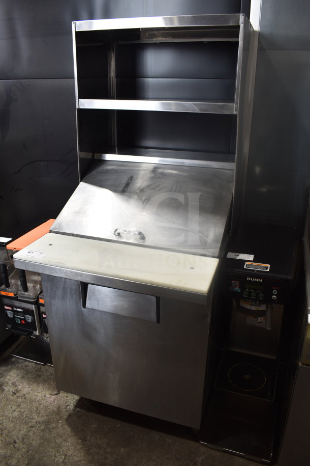 True TSSU-27-12M-B Commercial Sandwich Prep Table with 2-tier overshelf, stainless steel finish, on commercial casters.