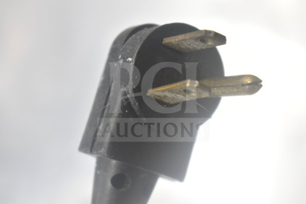 Close-up of a power plug for the True TSSU-27-12M-B commercial sandwich prep table.