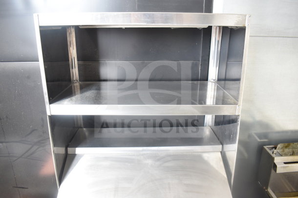 True TSSU-27-12M-B commercial sandwich prep table with 2-tier shelf, stainless steel, on casters. Model visible.