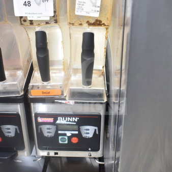 Bunn MHG commercial coffee grinder with two hoppers, missing lids. Labels show settings. 120 volts, 1 phase. Used condition.