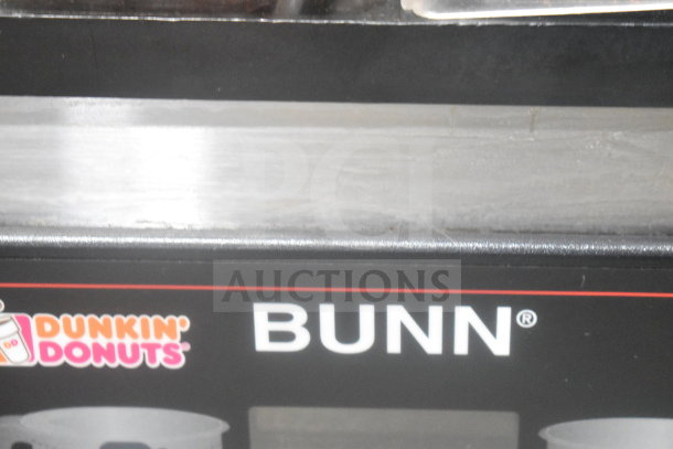 Bunn MHG coffee bean grinder, dual hopper, 120 volts, countertop model. Branding includes Dunkin' Donuts logo.