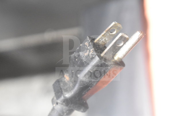 Alt text: Power plug of Bunn MHG Commercial Coffee Bean Grinder showing standard two-prong connection, some wear visible.